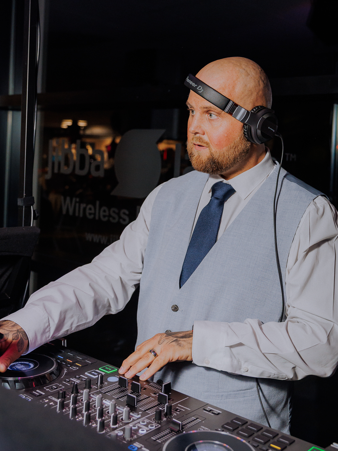 DJ Jordan H performing with headphones and DJ equipment
